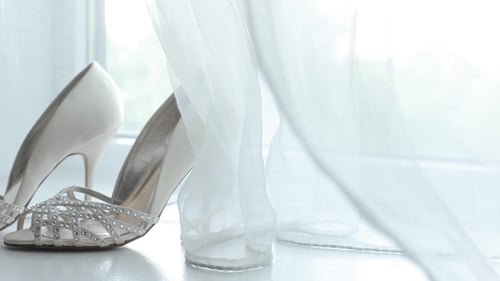 Elegant High Heels on White Sill Near Curtains