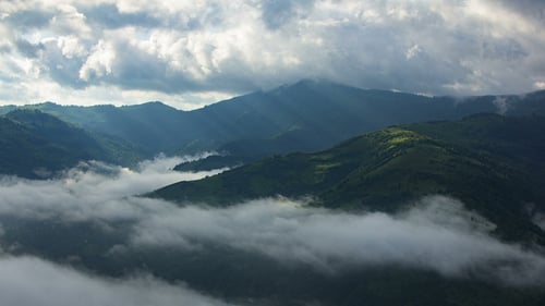 Timelapsed Scenery with Mountain Peaks and Cloudy Sky