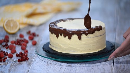 Applying Chocolate Drizzle to a Homemade Cake