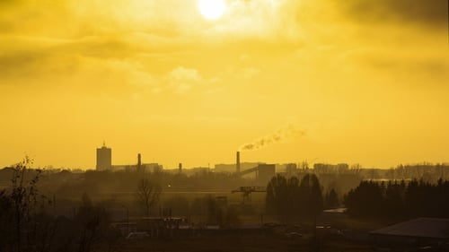 Silhouette of Dark City Against Sunset or Dawn Background