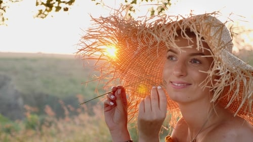 Woman in Straw Hat Posing at Sunset