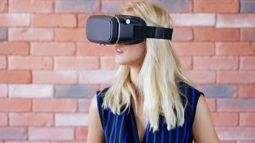 Woman Using Virtual Reality Headset Device Indoors