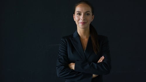 Confident Woman Smiling in a Black Blazer