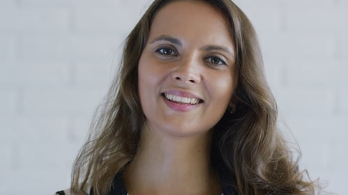 Woman Smiling and Touching Hair, Close Up Portrait