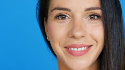 Woman Smiling Portrait Close Up on Blue