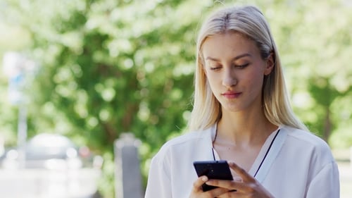 Young Lady Using Smartphone on Street