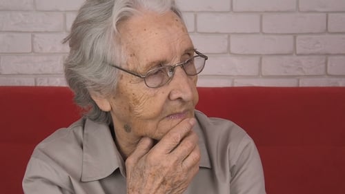 An Elderly Woman Thinks Sad Thoughts.