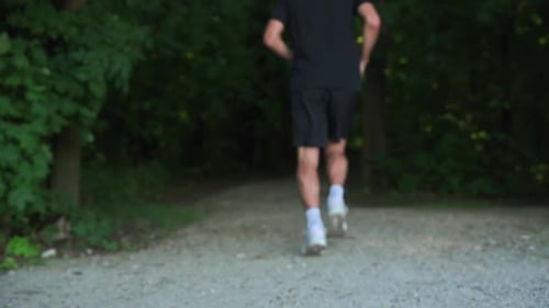Back View of Man Running in Park