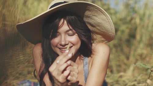 Portrait of a Village Girl in a Straw Hat with a Straw in Her Hands