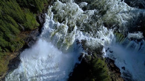 Aerial View of Waterfall Surrounded by Lush Forest