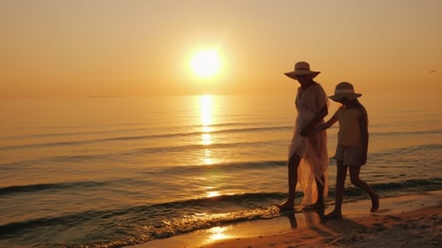 Mother and Child Strolling Along Beach at Sunrise