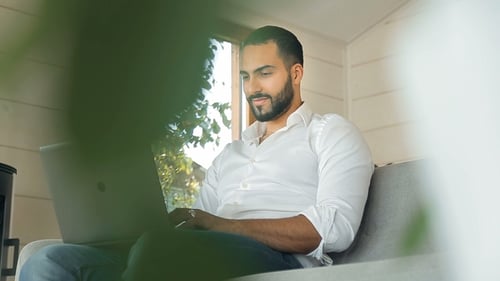 Man Working on Laptop at Home