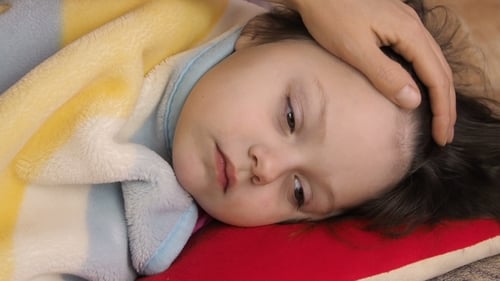 Caring Hand Touches Child's Forehead