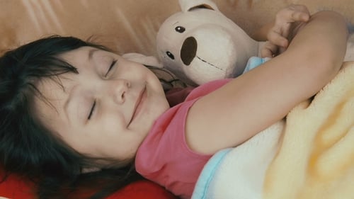 Smiling Child Napping Peacefully with Teddy Bear