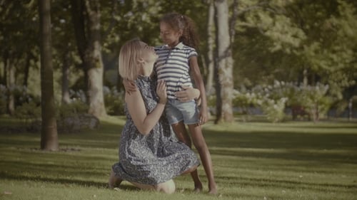 Loving Mother Bonding with Her Cute Girl in Park
