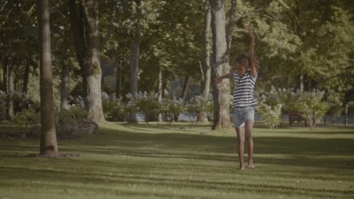 Active Little Girl Doing Cartwheel on Green Grass