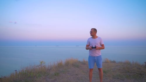 Quadrocopter Flies Over the Man's Head and Lands on His Hand