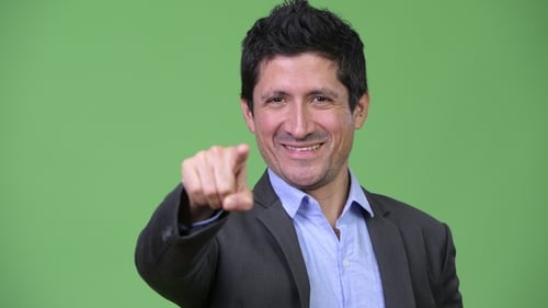 Happy Hispanic Businessman Pointing To Camera