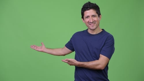 Happy Hispanic Man Showing Something