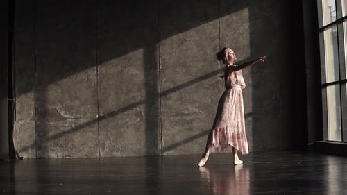 Elegant Ballerina Dancing Gracefully in a Sunny Studio