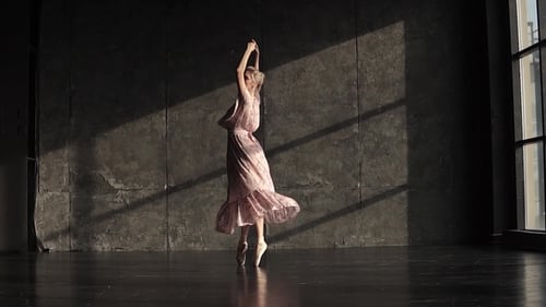 Elegant Ballerina Dances Gracefully in a Studio