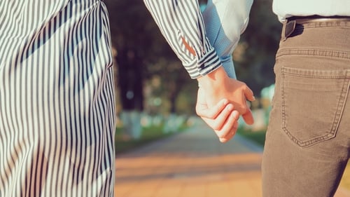 Romantic Young People and Love, Man and Woman Walking and Holding Hands in the City Park