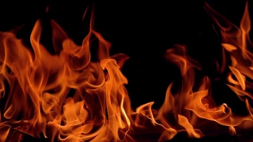 Burning Orange Flames Flickering Against Black Background