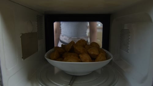 View From Microwave Oven Wife Takes Out Dish with Pies