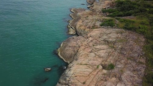 Aerial View of Rocky Sea Shore with Turquoise Water