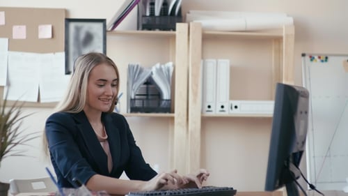 Call Center Employee at Work in the Office. A Young Girl Sitting at a Computer in the Office, Taking