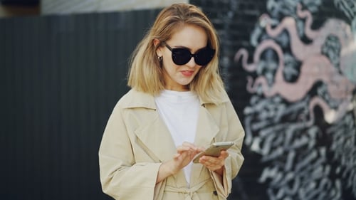 Stylish Woman Using Smartphone in Urban Setting