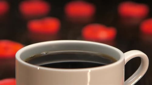 Cup of Hot Coffee on a Background of Hearts. Closeup