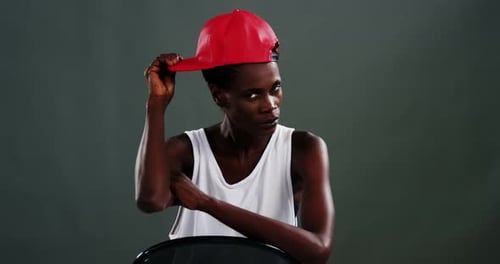 Confident Young Woman Posing with Baseball Cap
