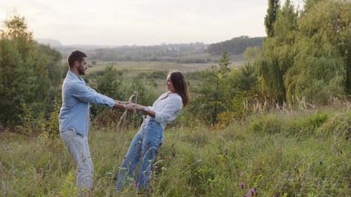 A Beautiful Girl and Boy Hugging in a Park