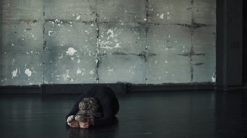 Young Man Doing Yoga on a Dark Background