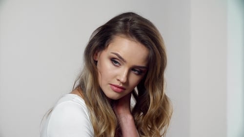 Woman with Wavy Hair Posing in Studio