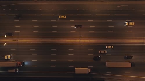 Cars on Illuminated Highway in City at Night