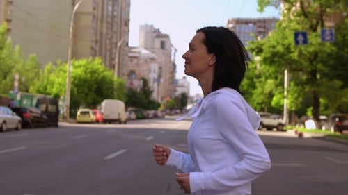 Woman Running Down the Street