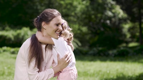 Loving Mother and Child Hugging in Green Park