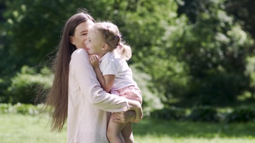 Happy Mother and Child Enjoying Sunny Day in Park