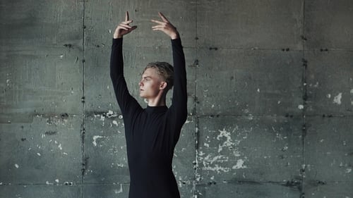 Man Performing Ballet Against Concrete Wall