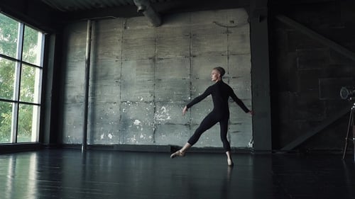 Male Ballet Dancer Dancing Against a Dark Background in the Studio
