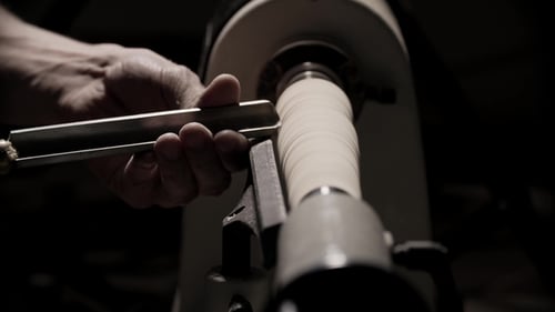 Man Working on Woodworking Lathe Machine in Carpenter Workshop with Copy Space