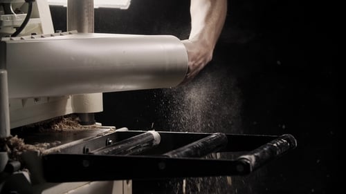 Man Cleans Wood Machine From Sawdust