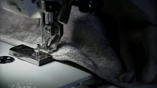View of Woman's Hands Working at Sewing Machine with Copy Space