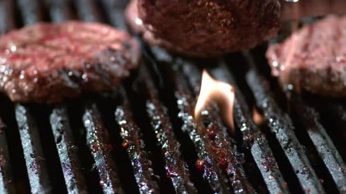 Hamburgers on grill in slow motion, shot on Phantom Flex 4K