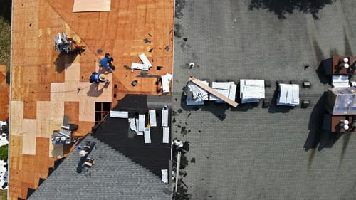 Removal of old roof and replacement with new roof shingle being applied home roof