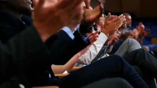Business executives applauding in a business meeting