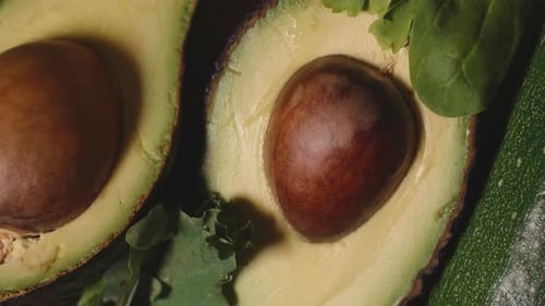 Close-Up of Fresh Avocado Halves with Greens