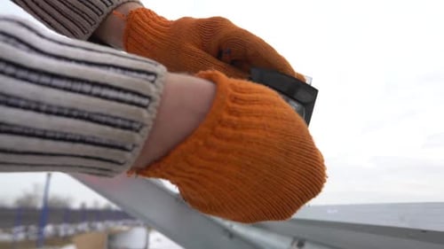 Nahaufnahme eines Mannes beim Zusammenbau eines Montageracks für den Bau von Sonnenkollektoren
